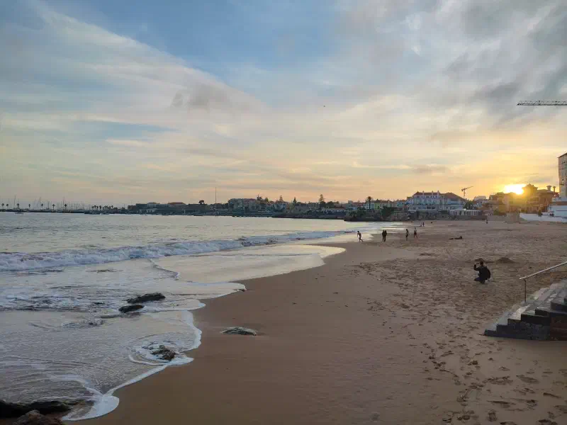 Cascais beach at sunset with the town beyond