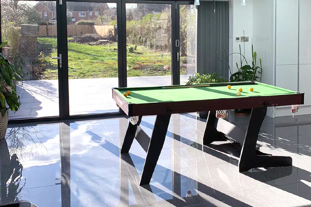 The finished open-plan extension in Walsall, with full-height sliding doors opening to the garden